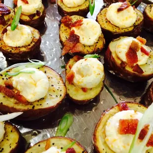 Potato skins, sour cream cheddar filling garnished with green onion &amp; bacon! YUM!!!!