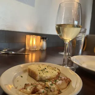 a plate of food and a glass of wine