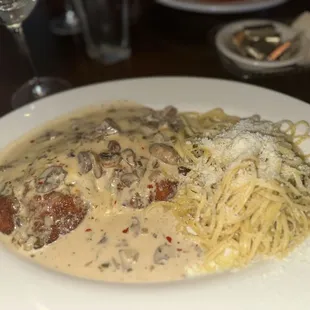 a plate of pasta and meatballs