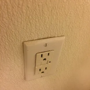 Dirty electrical outlet in the bathroom.