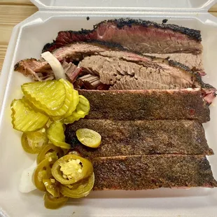 a tray of meat and pickles