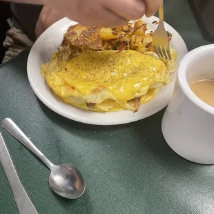 a plate of food and a cup of coffee