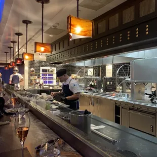 Chefs table with kitchen view. The staff was so kind, answering all my questions.