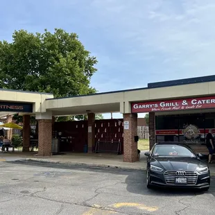 Restaurant on right, outdoor seating on left.