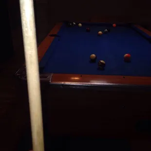 a pool table and a pool cue