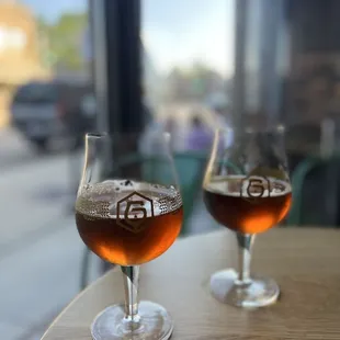 two glasses of beer on a table