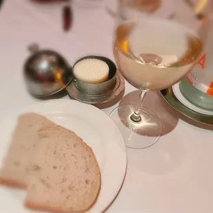 Bread and butter; glass of Chenin Blanc, Champalou, Vouvray, France 2021; bottle water.