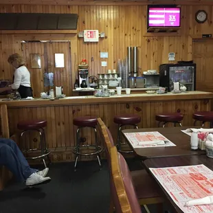 a restaurant with wood paneled walls