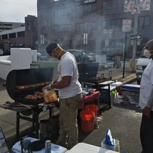 a man cooking on a grill