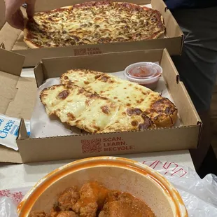 a pizza and a bowl of chicken wings
