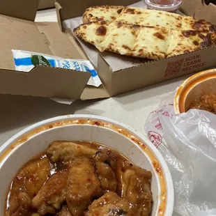 a pizza and a bowl of chicken