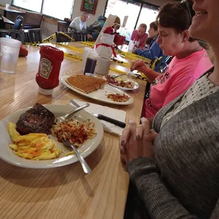 a woman sitting at a table with a plate of food