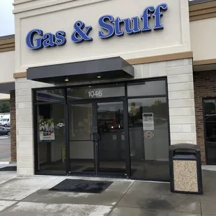 the entrance to a gas and stuff store