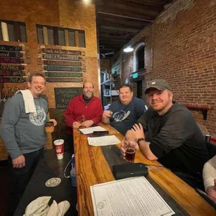 a group of men sitting at a bar