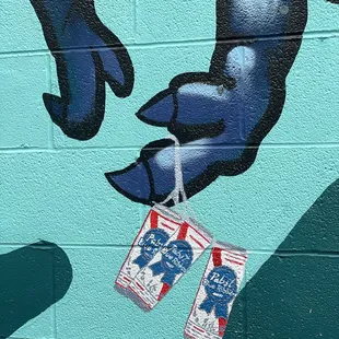 a hand holding a can of beer