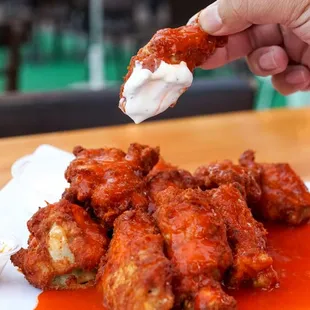 a plate of chicken wings with sauce