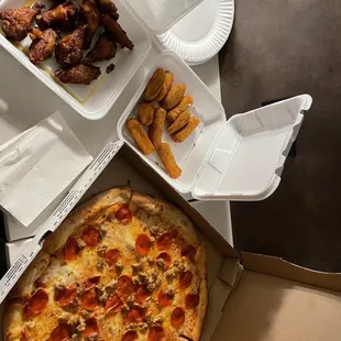 Pepperoni and sausage pizza, jalapeño poppers, mozzarella sticks, and chicken.