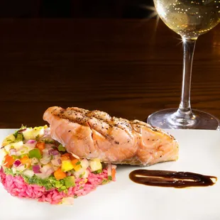 a plate of food and a glass of wine