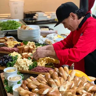 a man preparing a buffet