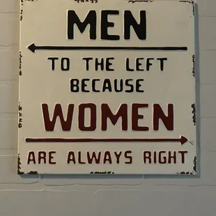 Sign between the restrooms