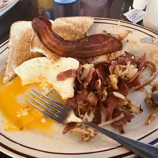 Photo after eating half of it :) corned beef hash with eggs and toast