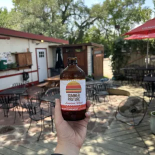 a person holding a bottle of beer