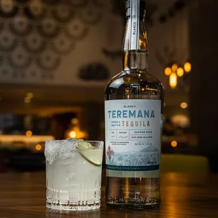 a close up of a bottle and a glass