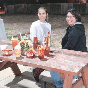 two women sitting at a picnic table