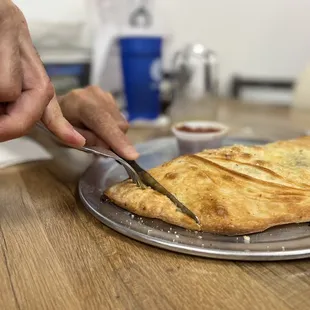 a person cutting a pie