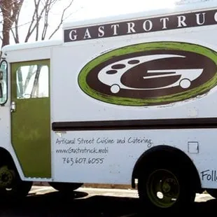 a white truck with a green logo