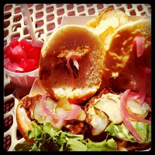 a sandwich with onions and lettuce