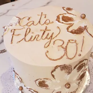 a white cake with brown decorations