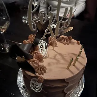 a chocolate cake with a high heel on top
