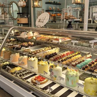 a display case of cakes and pastries