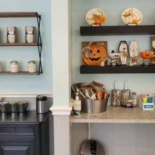 a kitchen with a counter and shelves