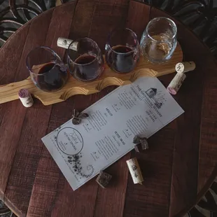 a table with wine glasses and a menu