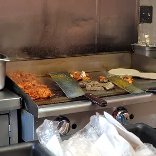 a grill with food cooking on it