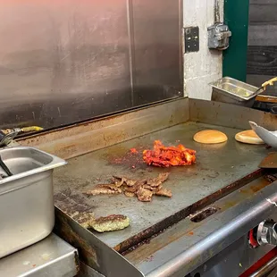 a grill with food cooking on it