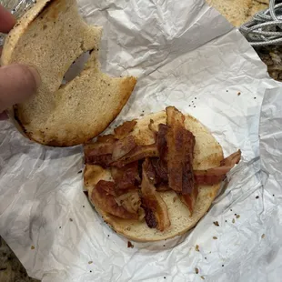 A mediocre attempt at a bagel with bacon and supposed to have cream cheese on it.