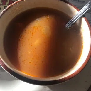 a cup of soup with a spoon in it