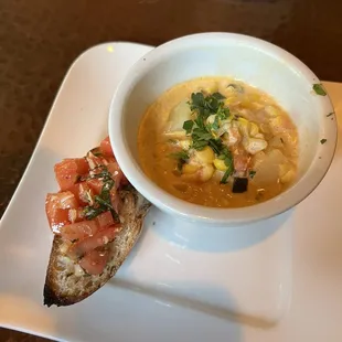 a bowl of soup and a piece of bread