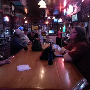 Custom made bar, and plenty of folks.