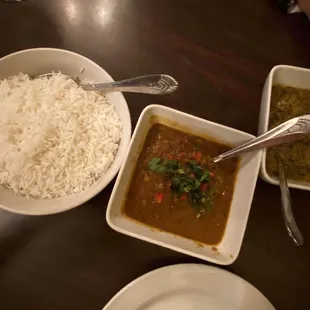 a bowl of rice, a bowl of curry, and a bowl of rice