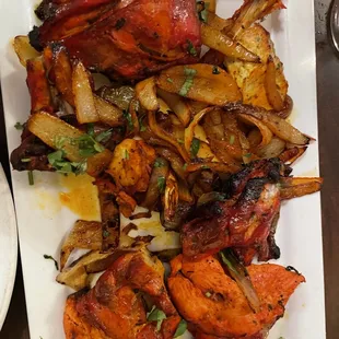 Gateway to India Tandori Platter...Notice the eaten chicken leg in upper right corner!.Also cam on 1/2 the size plate from the last 3 visits