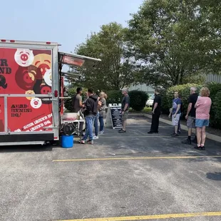 a group of people standing in a parking lot
