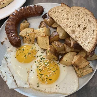 a plate of food with eggs, sausage and toast