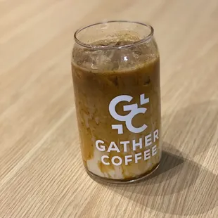 a glass of coffee on a table