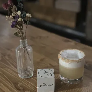 a drink and a note on a table