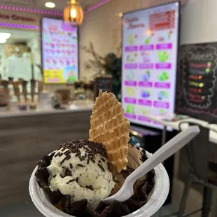 Pistachio flavor ice cream in a chocolate covered waffle bowl