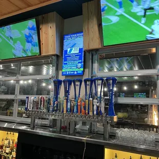 Digital advertising in the center of the bar shows Gator's specials but also outside advertising like this one for a roofing company.